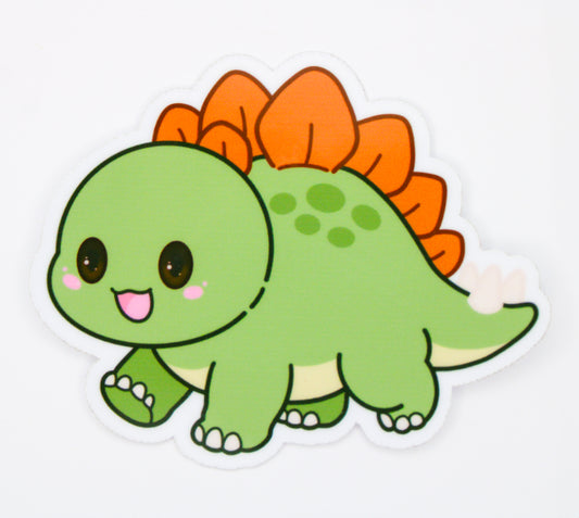 A cute cartoon dinosaur sticker or decal featuring a green kawaii Stegosaurus with orange spikes, large black eyes, and a white outline on a plain white background.