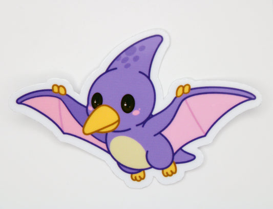 A die-cut vinyl sticker of a cute purple cartoon pterosaur flying, shown on a plain white background.