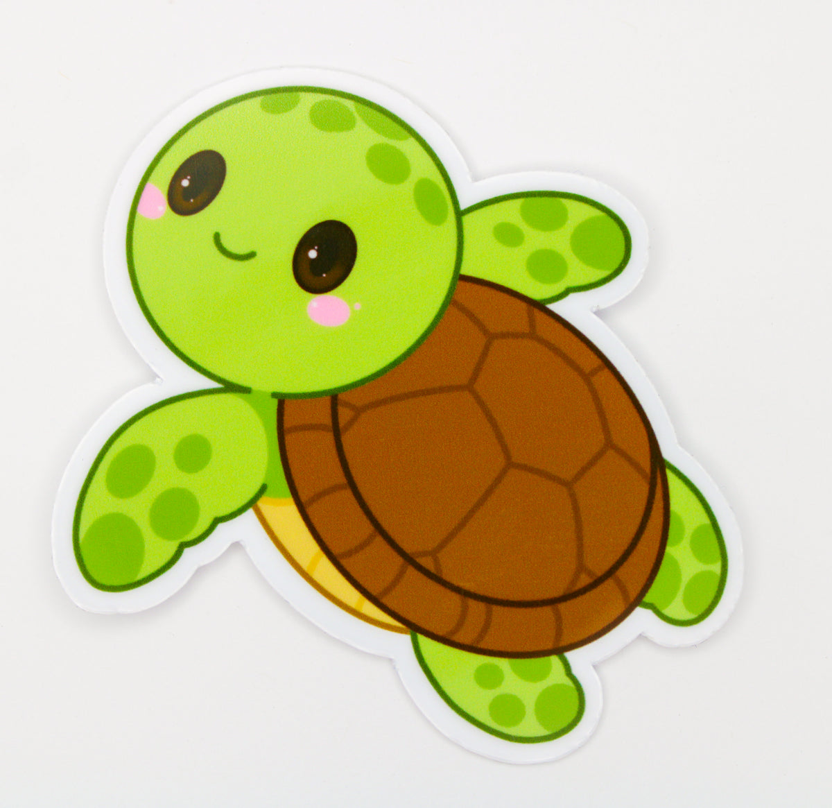 A cute cartoon sea turtle sticker with a green head and flippers, a brown shell, and a small yellow underside, shown on a plain white background.
